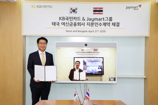 이동철(왼쪽) KB국민카드 사장이 27일 서울 종로구 KB국민카드 본사에서 온라인 화상 계약 방식으로 진행된 태국 여신전문금융회사 제이 핀테크 지분 인수 계약식에서 아디삭 수쿰비타야 제이마트 그룹 회장과 기념 촬영을 하고 있다.  KB국민카드 제공